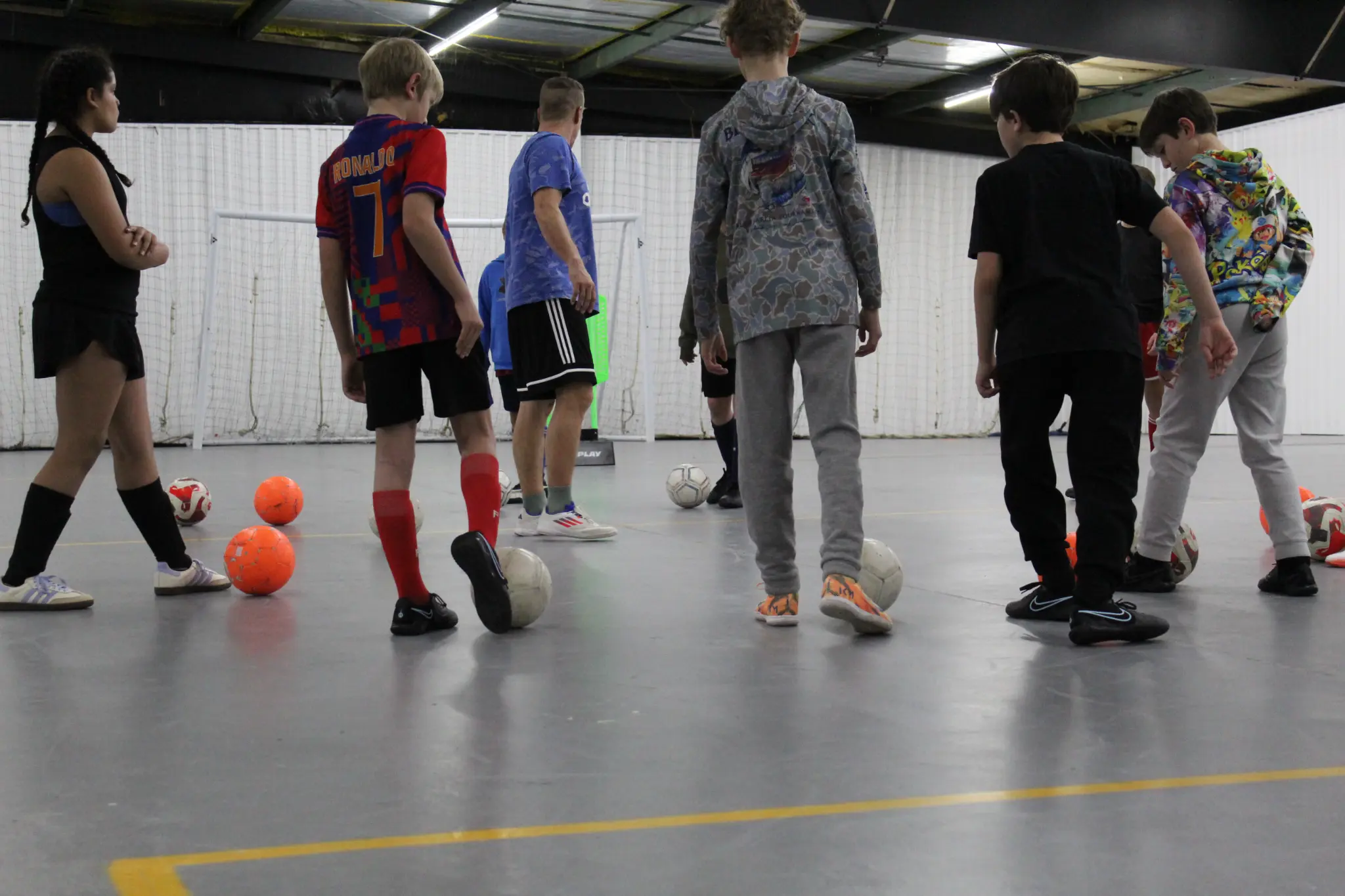 Athletes working on ball mastery in an indoor JFA training session