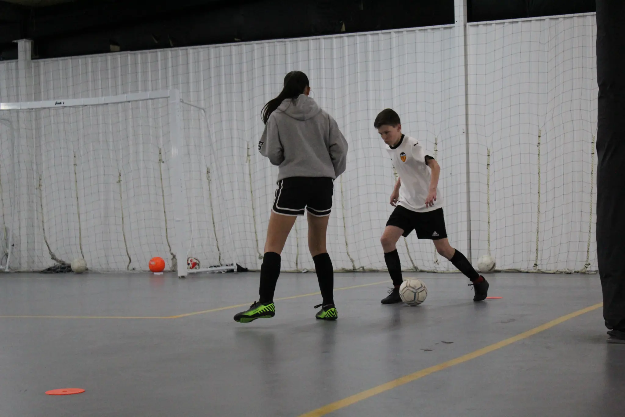 Coach leading a foundational futsal training group at JFA