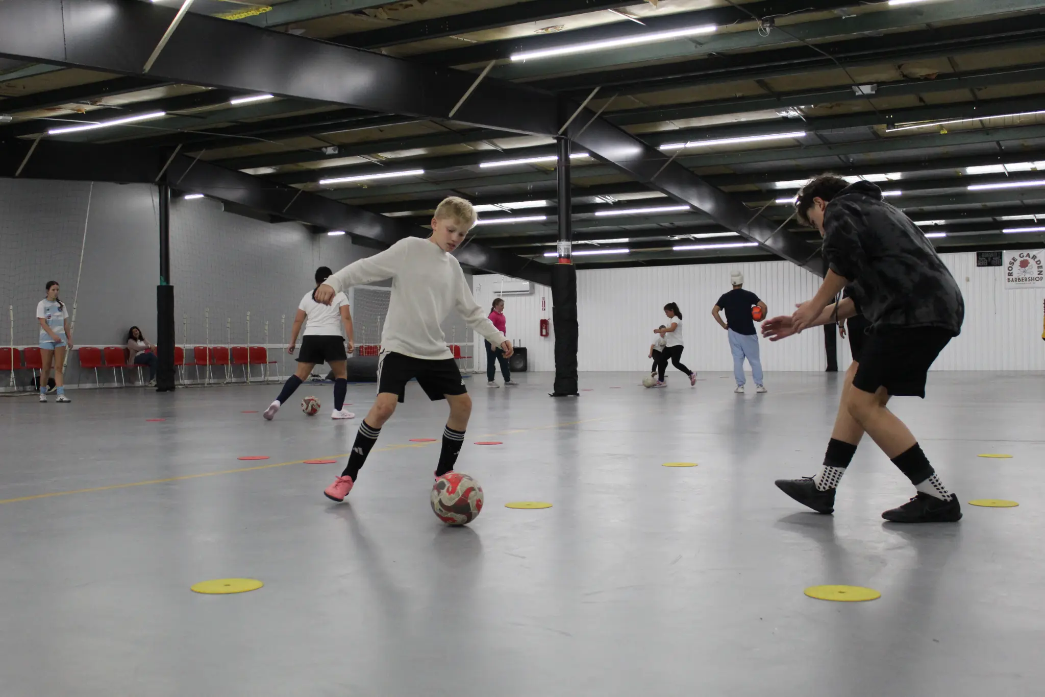 Youth athletes practicing technical soccer skills inside Jacksonville Futsal Academy