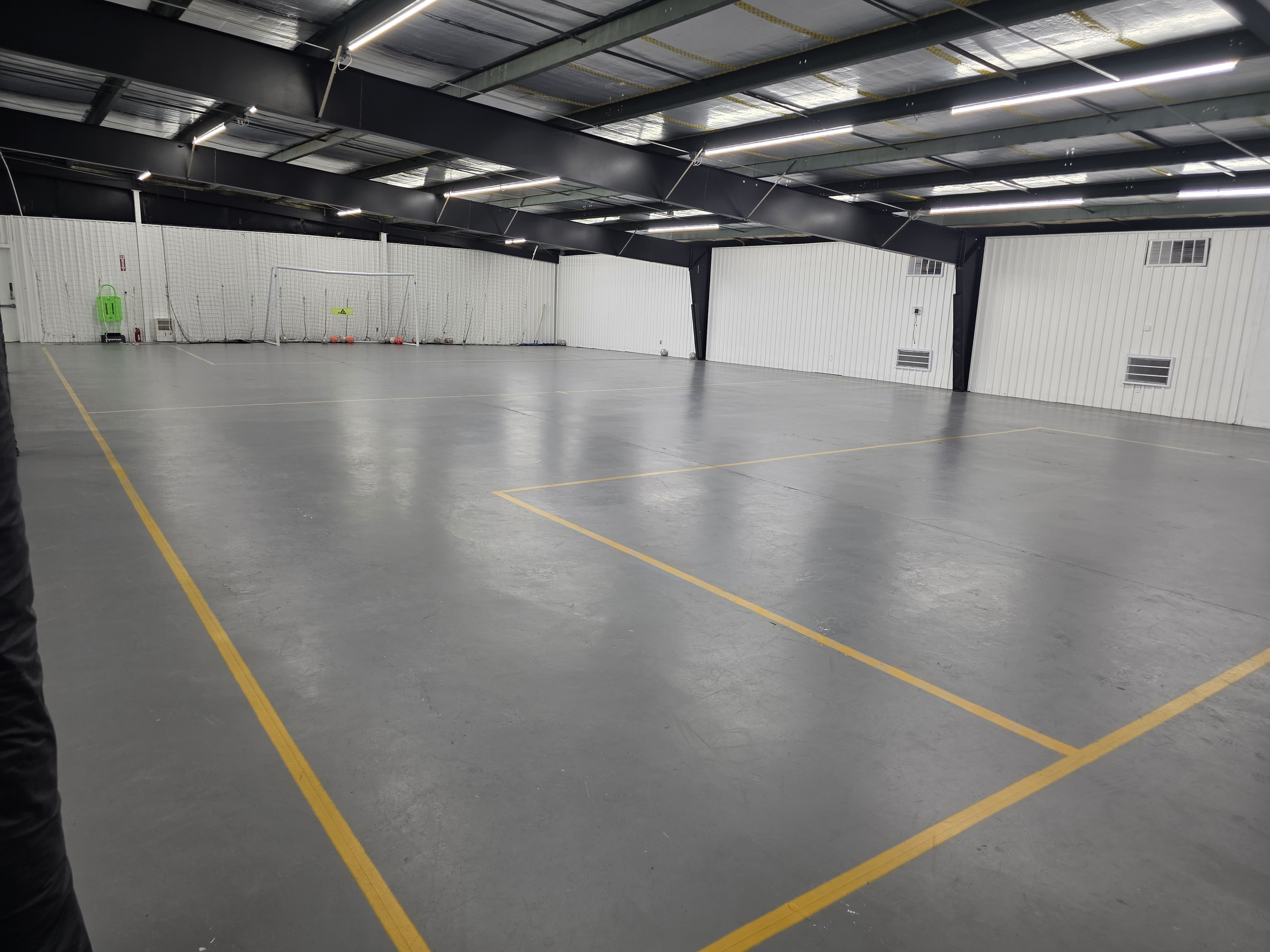 Full view across a Jacksonville Futsal Academy indoor futsal court