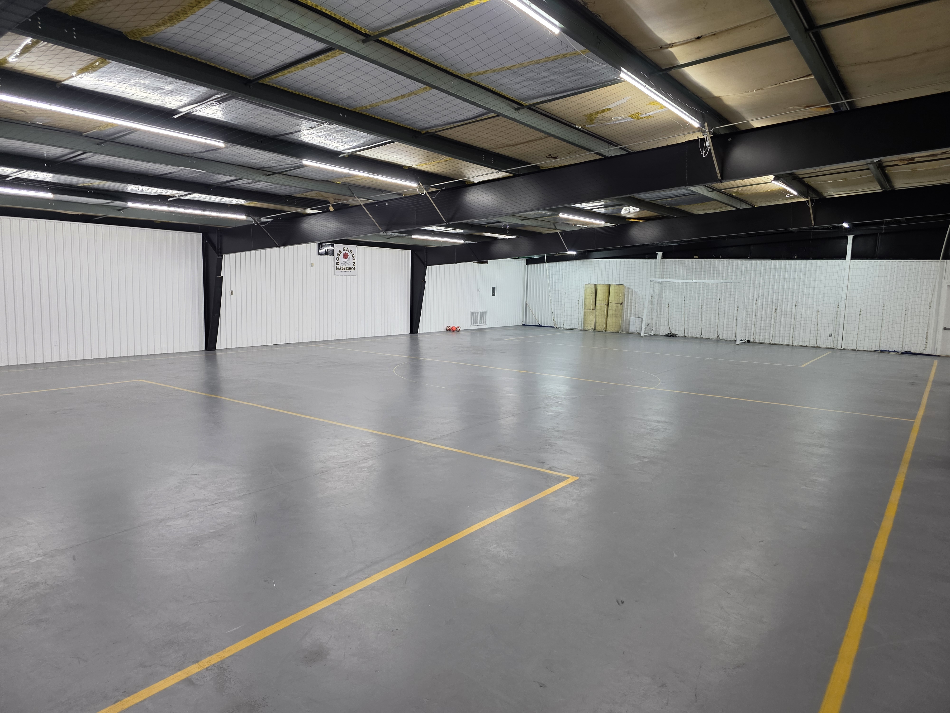 Wide-angle view of an empty Jacksonville Futsal Academy indoor court